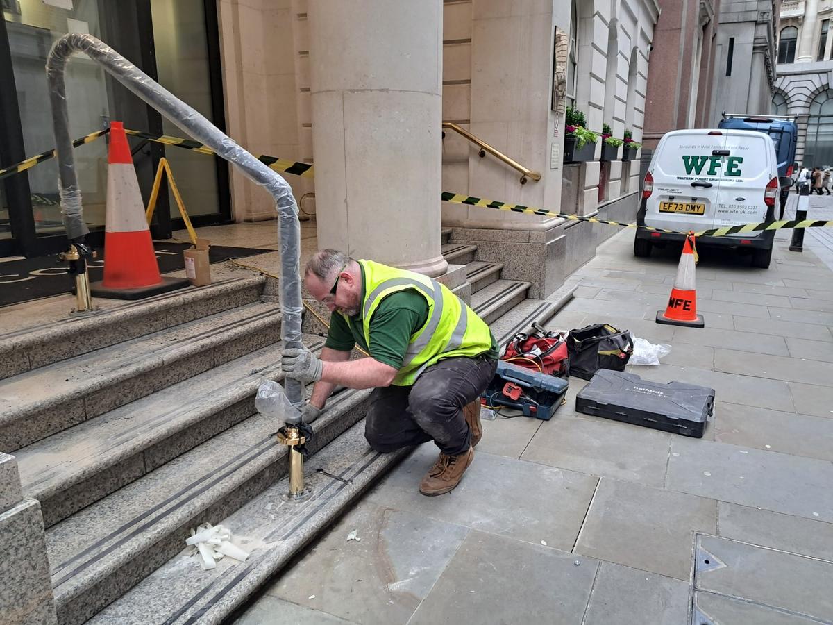 BRASS HANDRAIL BEING INSTALLED